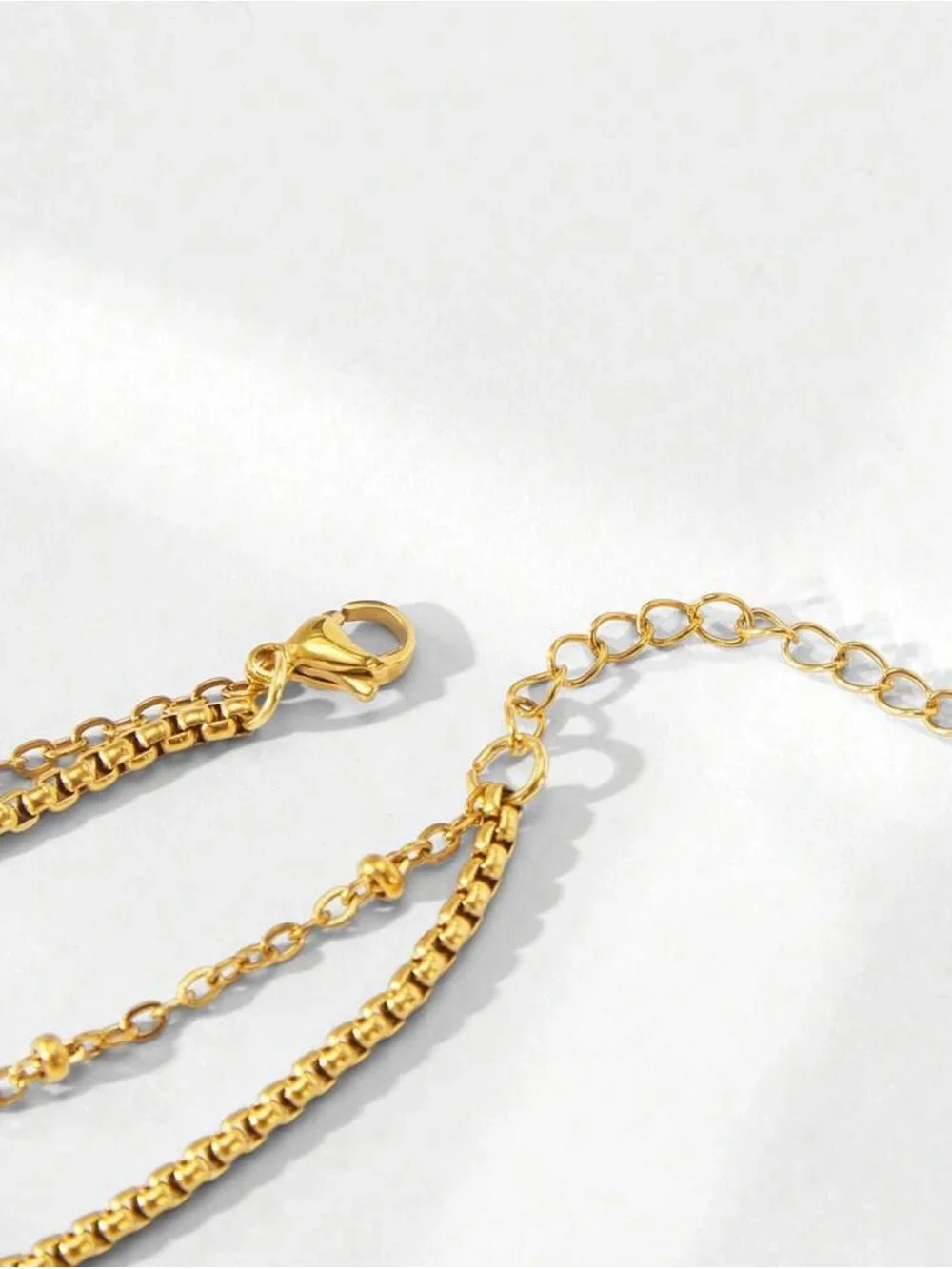 Gold Multi chain Bracelet with Black  Clover Charm